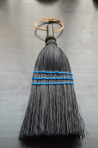 black whisking hand broom